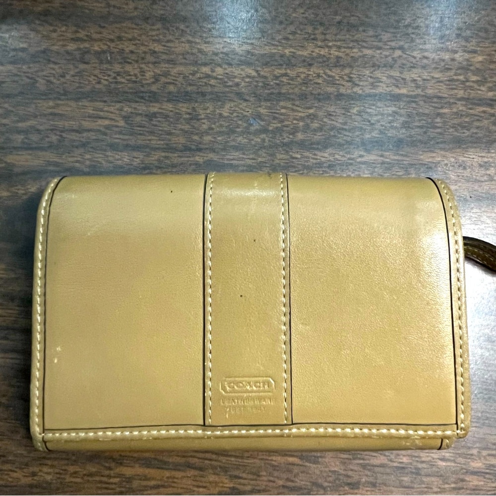 Coach tan leather bi-fold wallet.